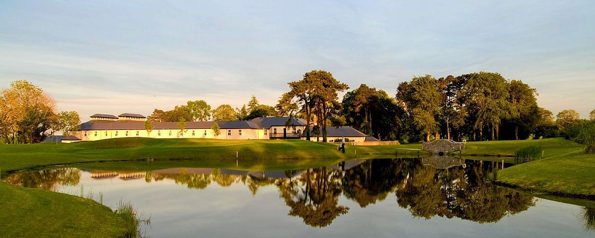 A view of the lake and grounds of Roganstown Golf and Country Club in the evening sunshine