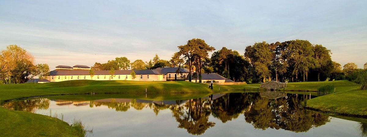 A view of the lake and grounds of Roganstown Golf and Country Club in the evening sunshine