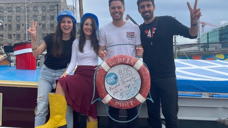 A group of friends on the deck of the Escape Boat