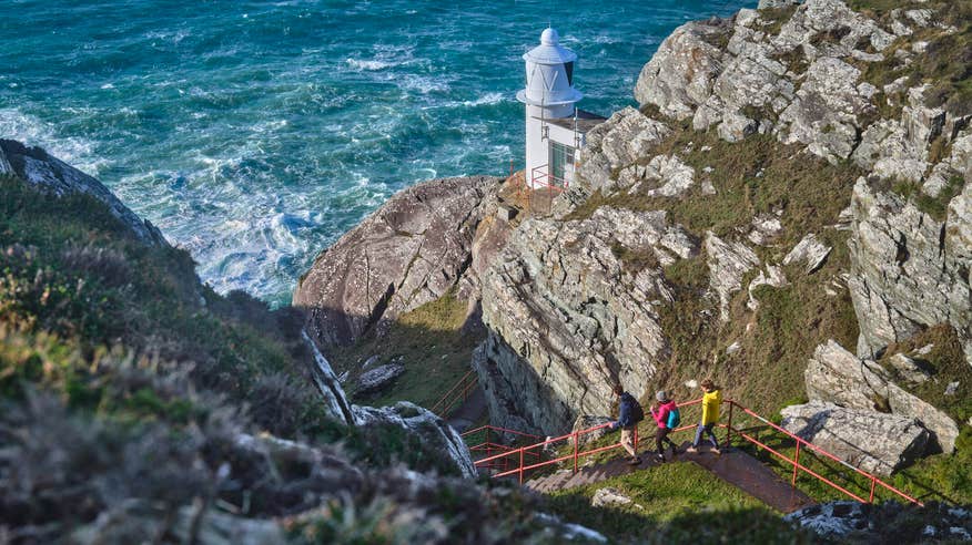 People walking on the Sheep's Head Lighthouse Trail in County Cork.
