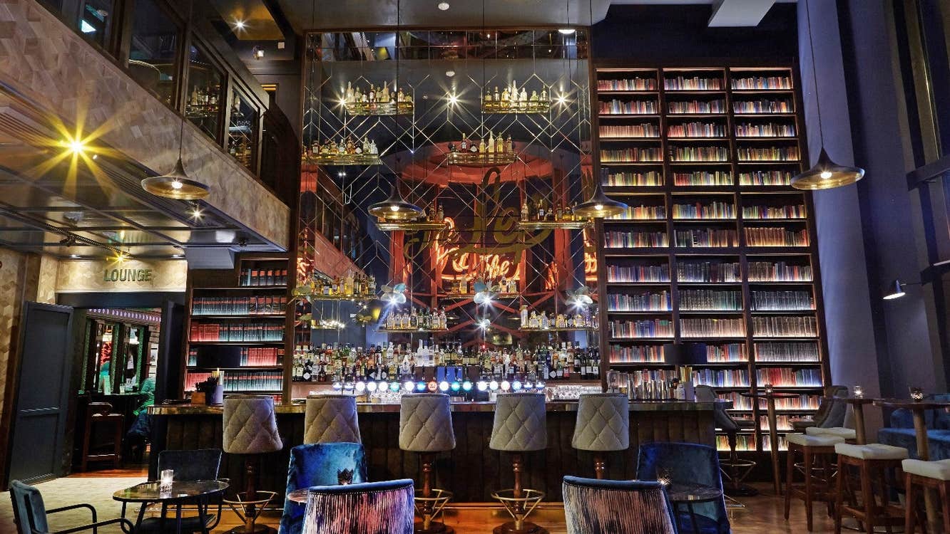 A bar with tall glass displays stretching to a high ceiling