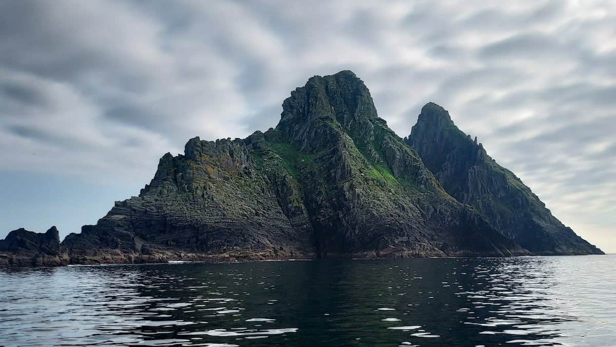 A triangular shaped rocky island in the ocean