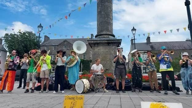 Birr Vintage Week & Arts Festival 2026, a large group of musicians playing outdoors standing in a line under a tall column