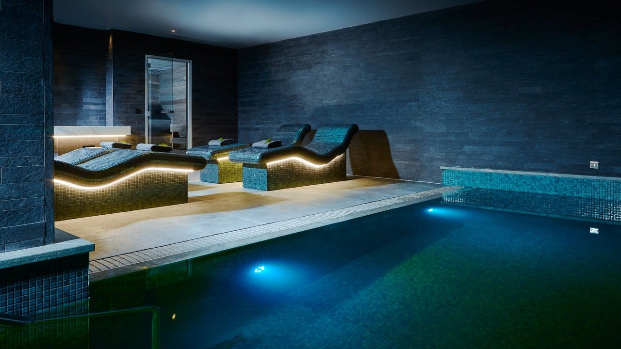 A relaxation pool with underwater lighting with heated loungers