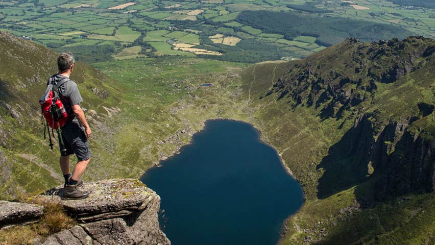 A hillwalker takes a moment to enjoy the spectacular scenery all around him