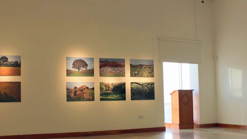 View of gallery with paintings displayed on the walls