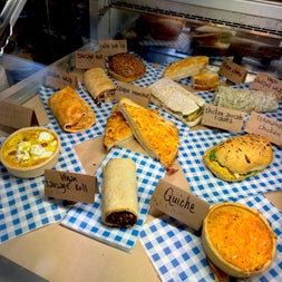 Selection of sandwiches and pastries on blue and white checked serviettes