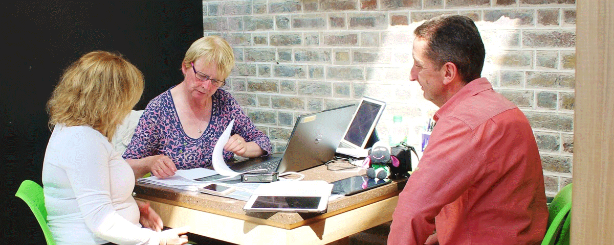 Two people with a historian at the Irish Family History Centre