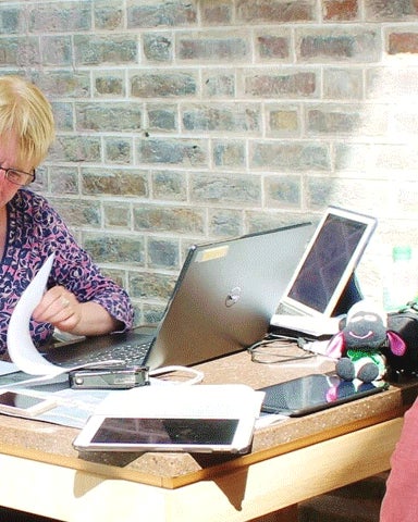 Two people with a historian at the Irish Family History Centre