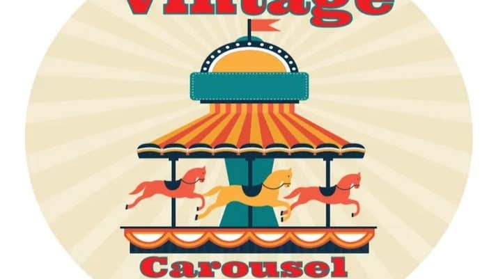 Image of an old fashioned roundabout/carousel with horses in green, red and yellow colours