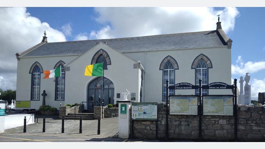 Exterior of a tourist office with flags flying outside