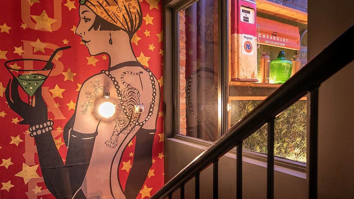 A painting of a lady drinking a cocktail in Brubakers Bar & Restaurant