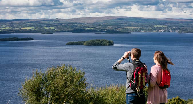 A couple using binoculars to look out over Lough Derg, County Tipperary