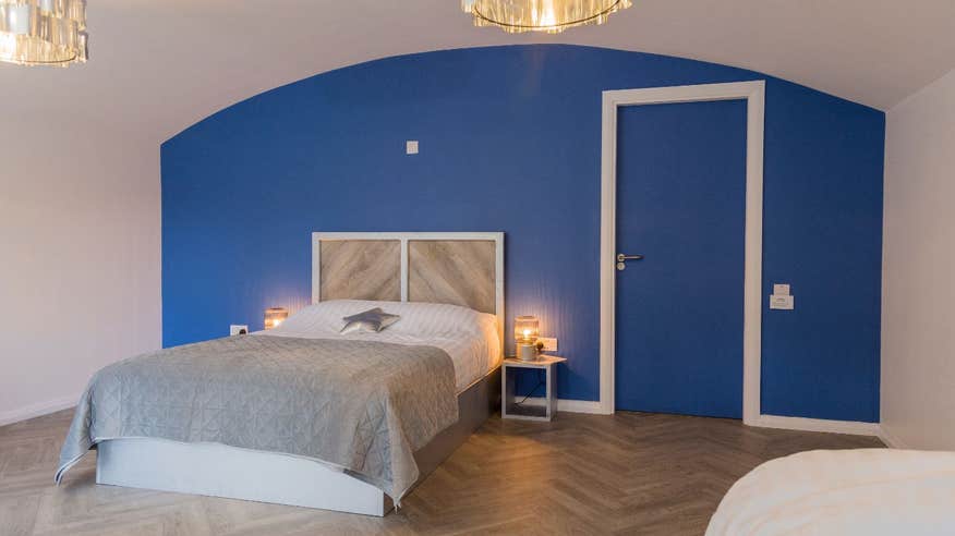 A glamping room at Glamping Under The Stars with a blue accent wall and white trim.
