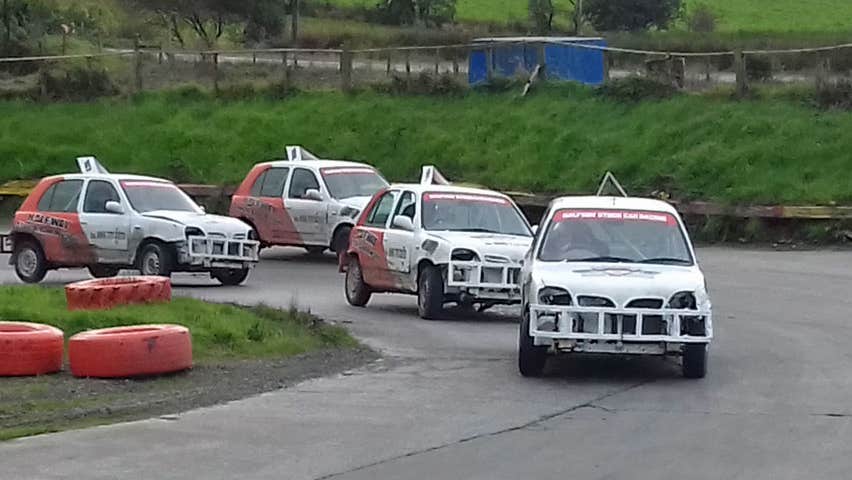 Image of four stockcars racing around bend