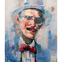 Portrait of a man with glasses wearing a blue suit a hat and a red bow tie
