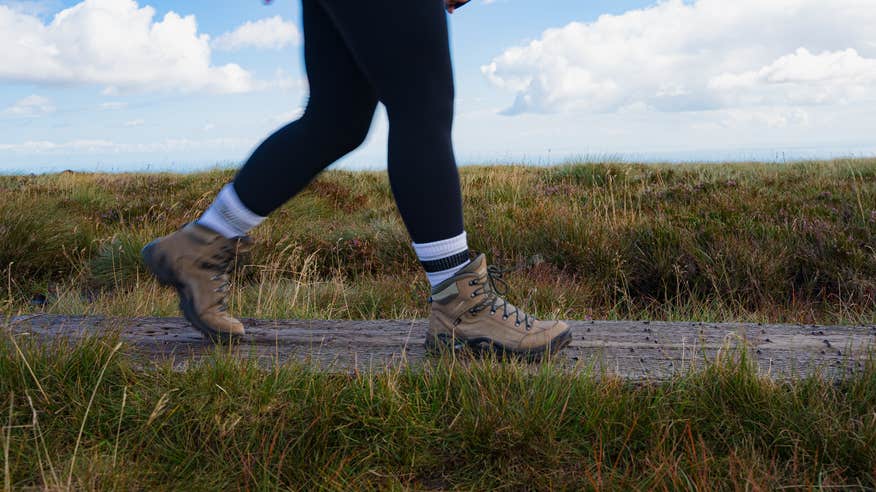 Close up of women's legs walking in hiking boots.