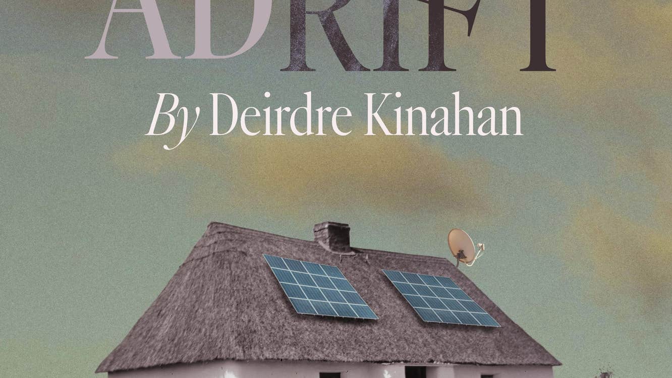 Adrift at Backstage Theatre Longford, a car parked in front of a white thatched cottage with 2 solar panels on the roof.