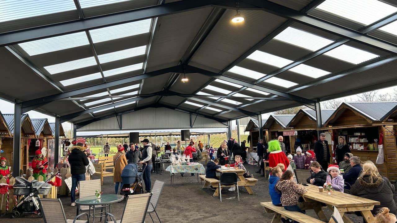 People walking around market stalls