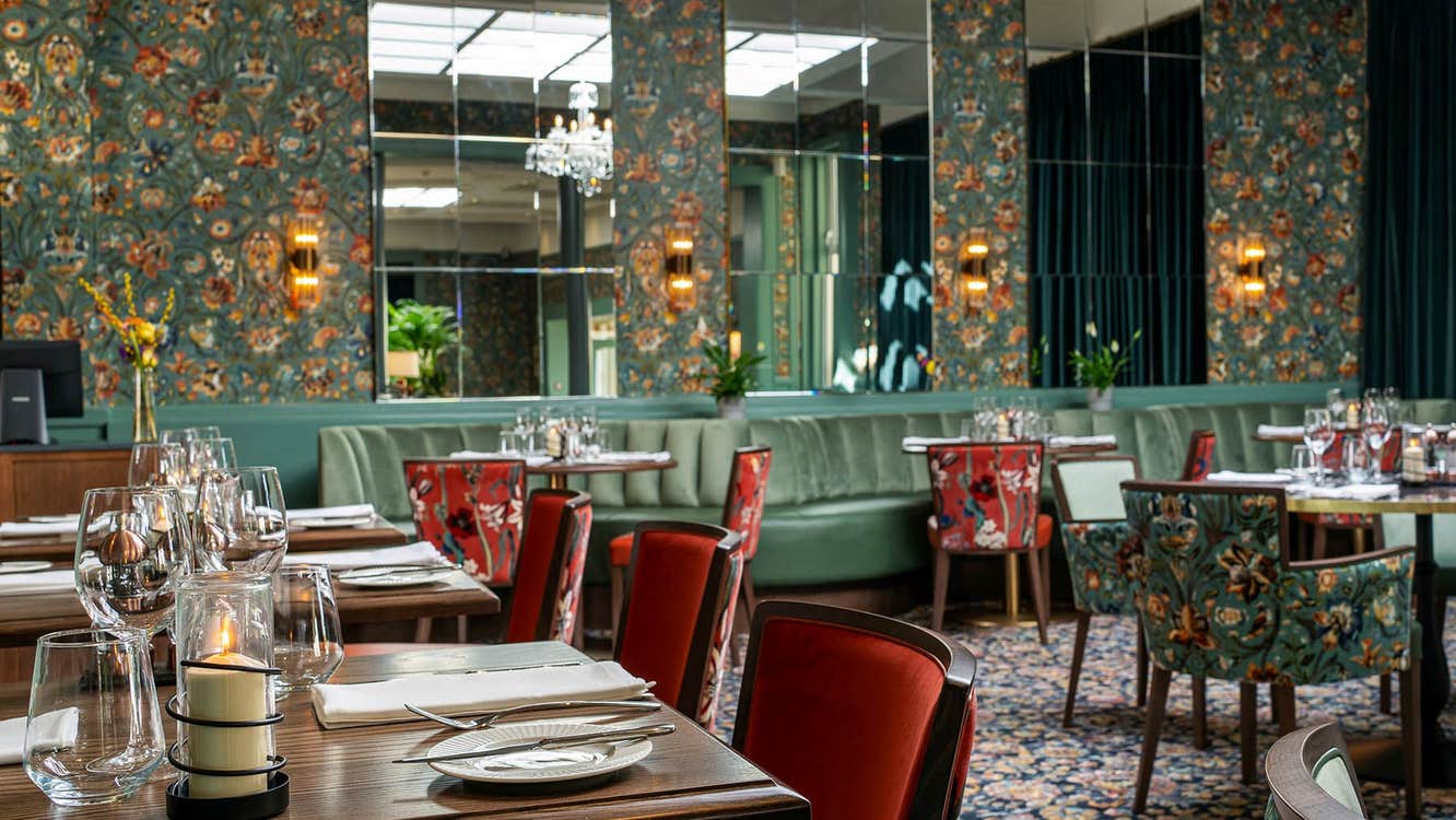 Elegant interior of The Proleek Restaurant with comfortable chairs and chandeliers