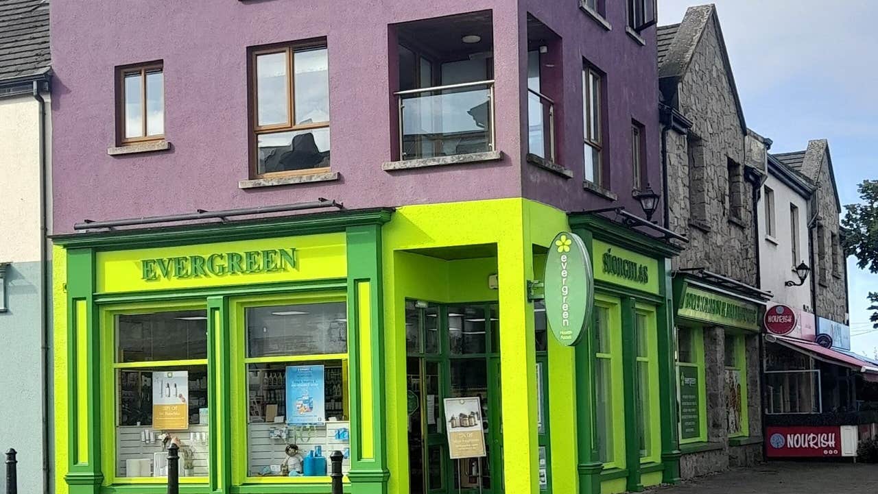 The green and yellow exterior of a health food shop