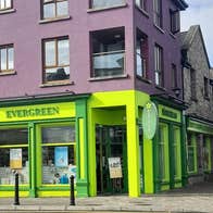 The green and yellow exterior of a health food shop
