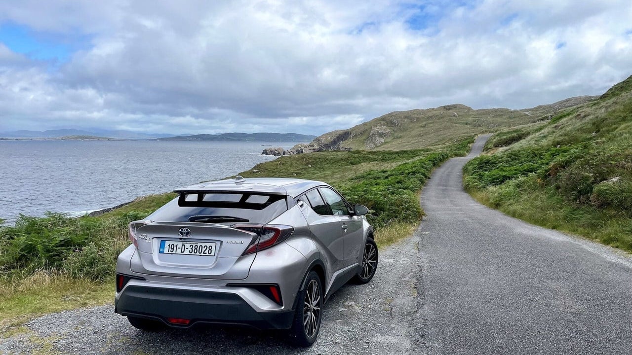 A large car parked beside the coast