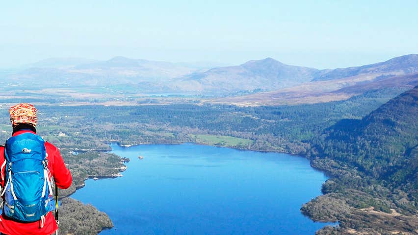 A hiker overlooking a lake in Killarney National Park