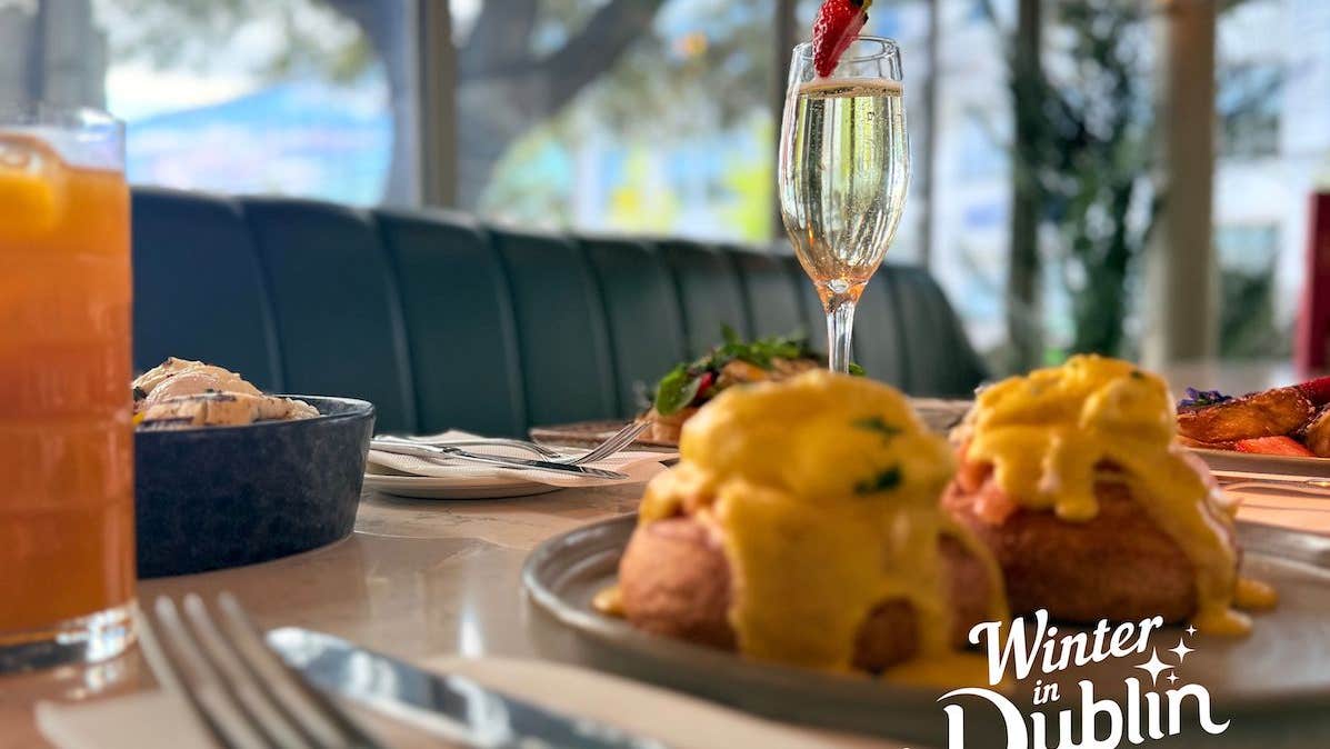 Image of brunch display with eggs royale, and a glass of prosecco
