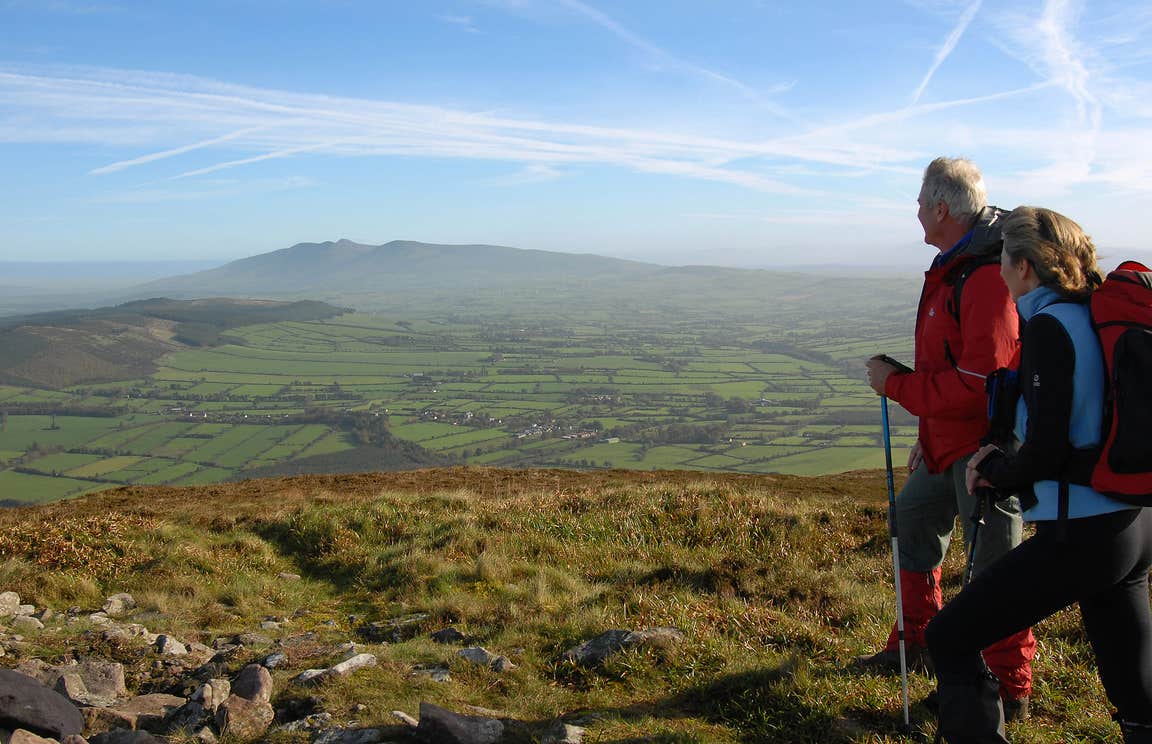 Two Hikers in the Munster Vales on a bright day