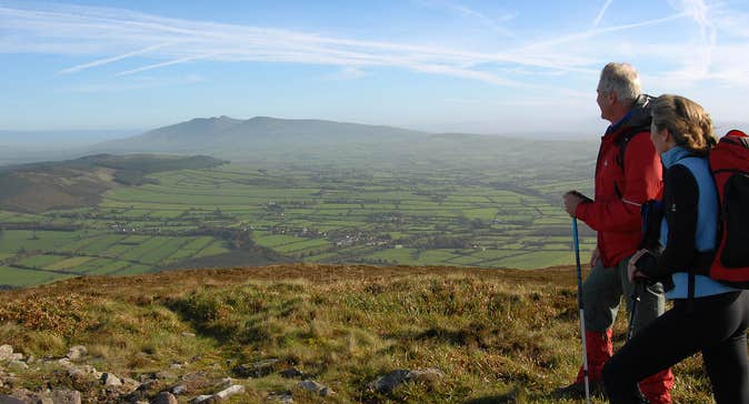 Two Hikers in the Munster Vales on a bright day