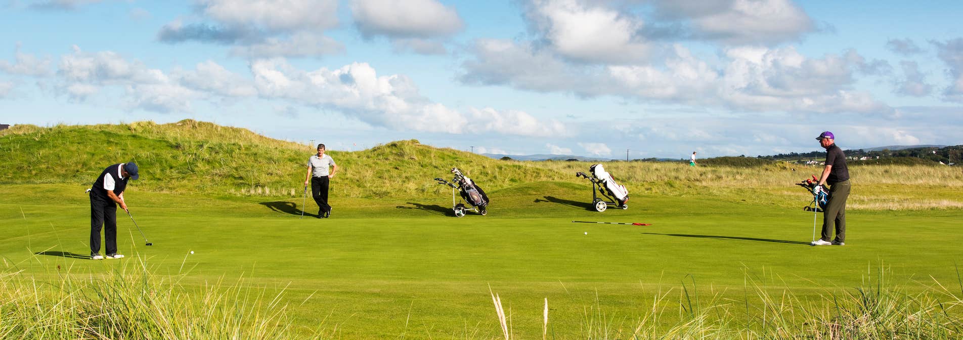 Three golfers at Ballyliffin Golf Course in County Donegal