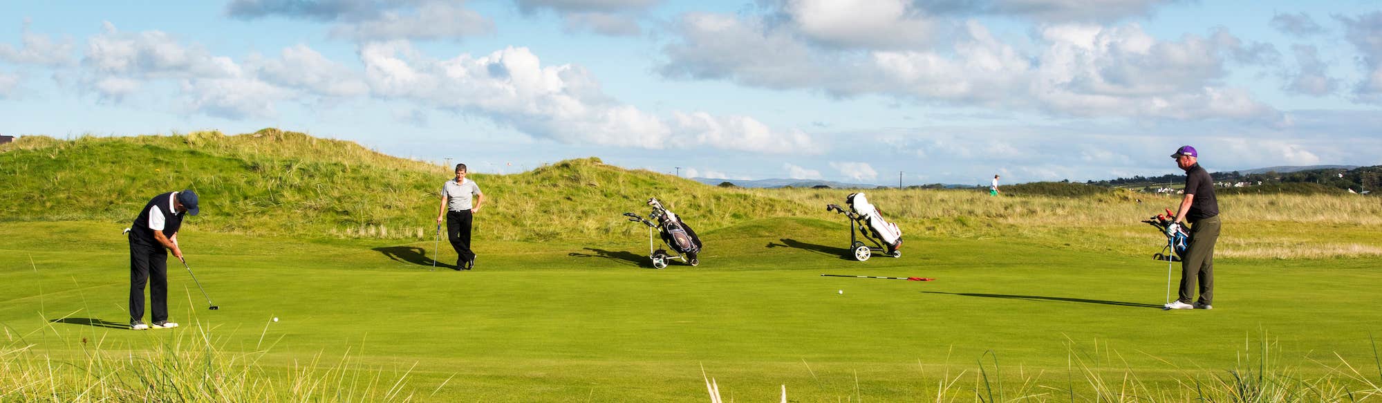 Three golfers at Ballyliffin Golf Course in County Donegal