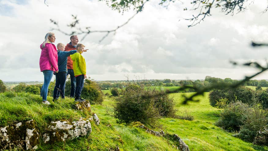 A family of four looking out from Hill of Uisneach in County Westmeath.