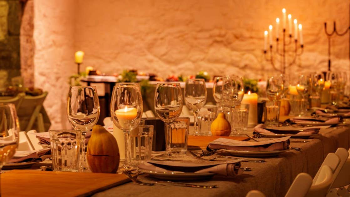 Firelit courtyard with medieval-inspired cocktails, setting the mood for a vibrant, interactive long-table feast.