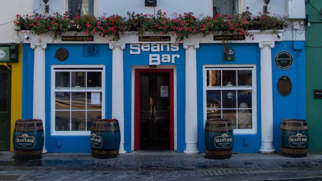 Exterior facade of Seans Bar in Athlone painted blue with white columns.