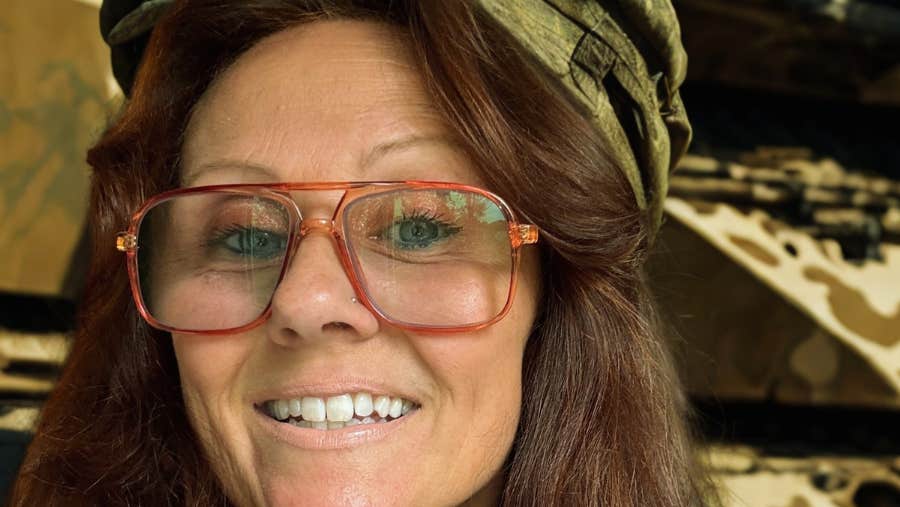 Close up view of person wearing a large pair of glasses and a cloth cap