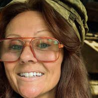 Close up view of person wearing a large pair of glasses and a cloth cap