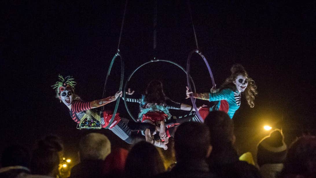 Three circus performers dressed up in Halloween costumes on a high wire act at the Púca Festival in Meath.