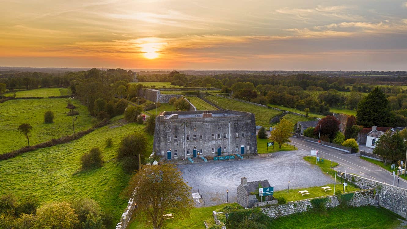 An aerial view of Shannon Fortifications with the sun setting behind the building