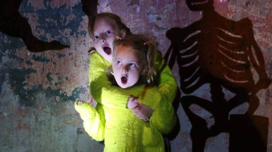 Children wearing brightly-coloured clothes at a Halloween event