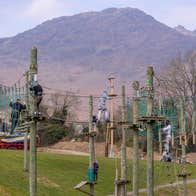 Children walking along suspended rope bridges