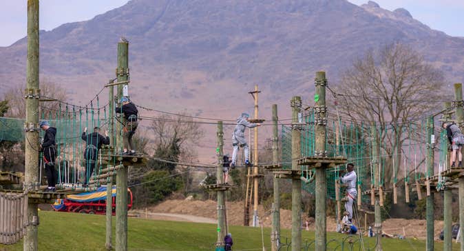 Children walking along suspended rope bridges
