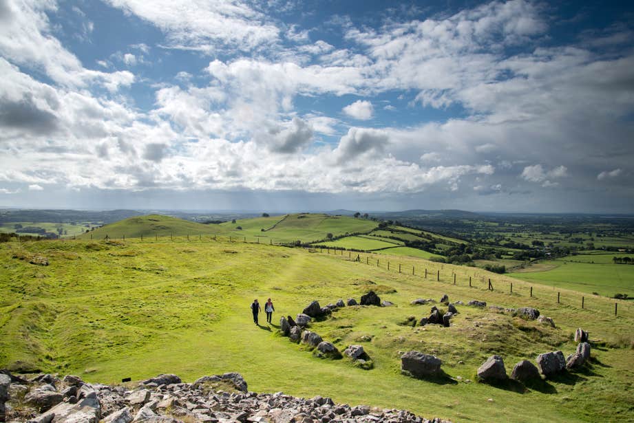 Two people exploring Loughcrew Cairns in County Meath