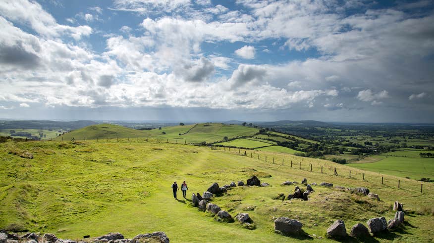 Two people exploring Loughcrew Cairns in County Meath