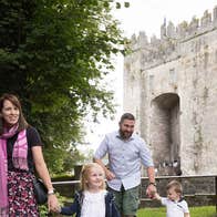 A family walking within the grounds of Bunratty Castle and Folk Park