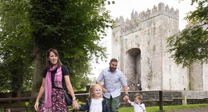 A family walking within the grounds of Bunratty Castle and Folk Park