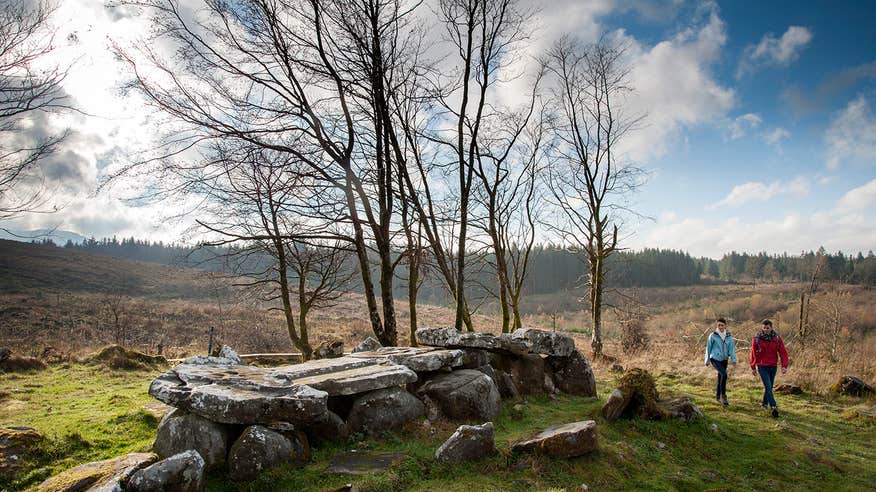 A couple exploring a tomb in the Cavan Burren Park, County Cavan