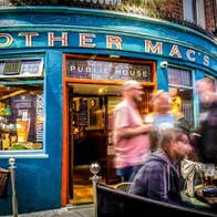 The exterior of Mother Macs pub with people standing outside