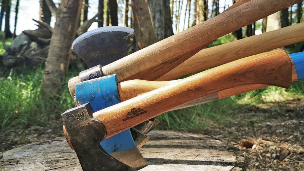 Axe Club view of four axes embedded in wood slab